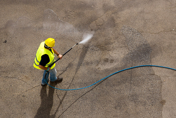 water jetting association worker jetting a concrete surface